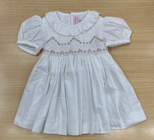 White smocked dress with embroidered pink rosettes
